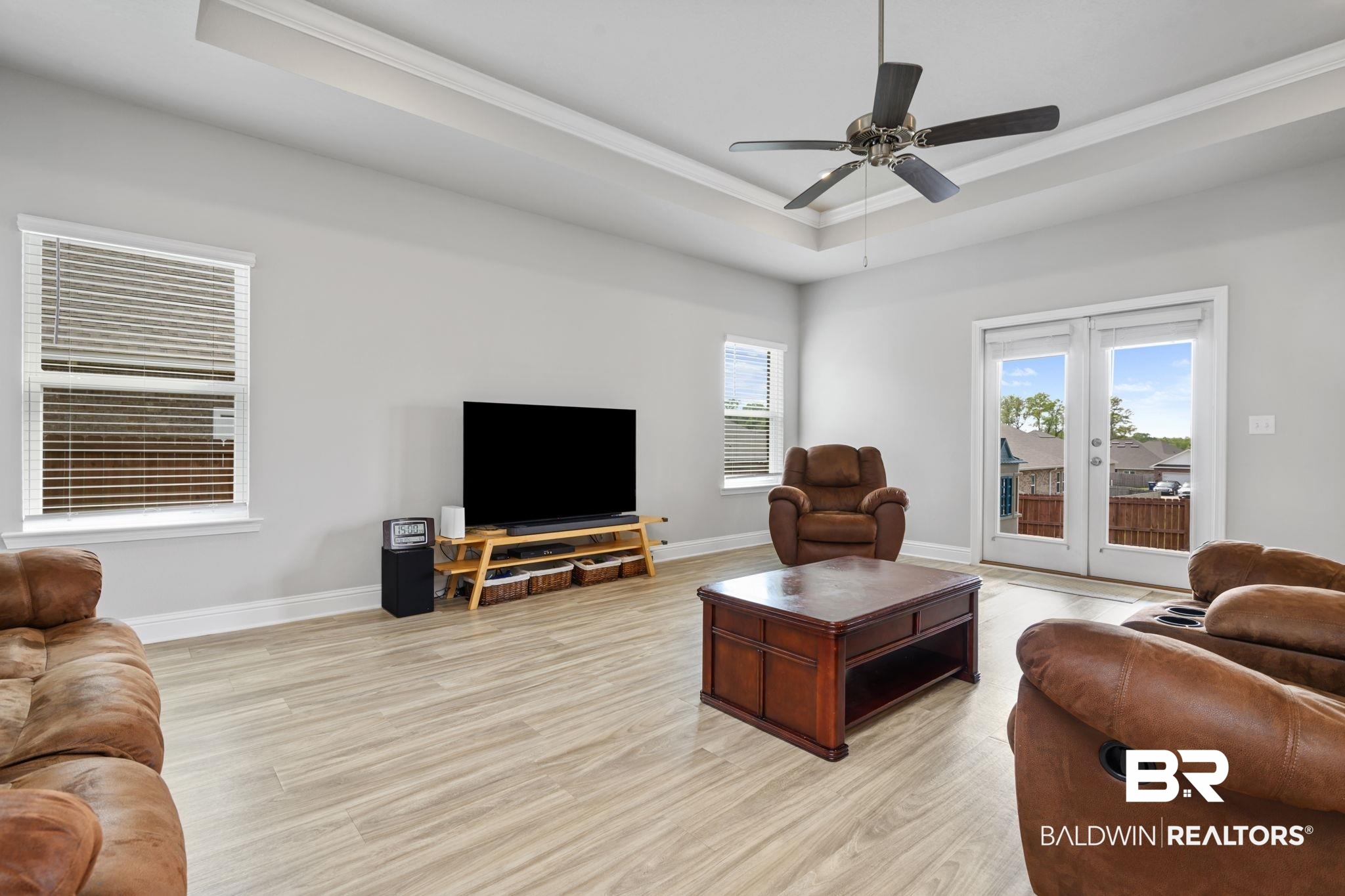 2183 Meadowview Loop Semmes, AL 36575 - Photo 32 of 58 Living room with light wood finished floors, ceiling fan, ornamental molding, a raised ceiling, and french doors