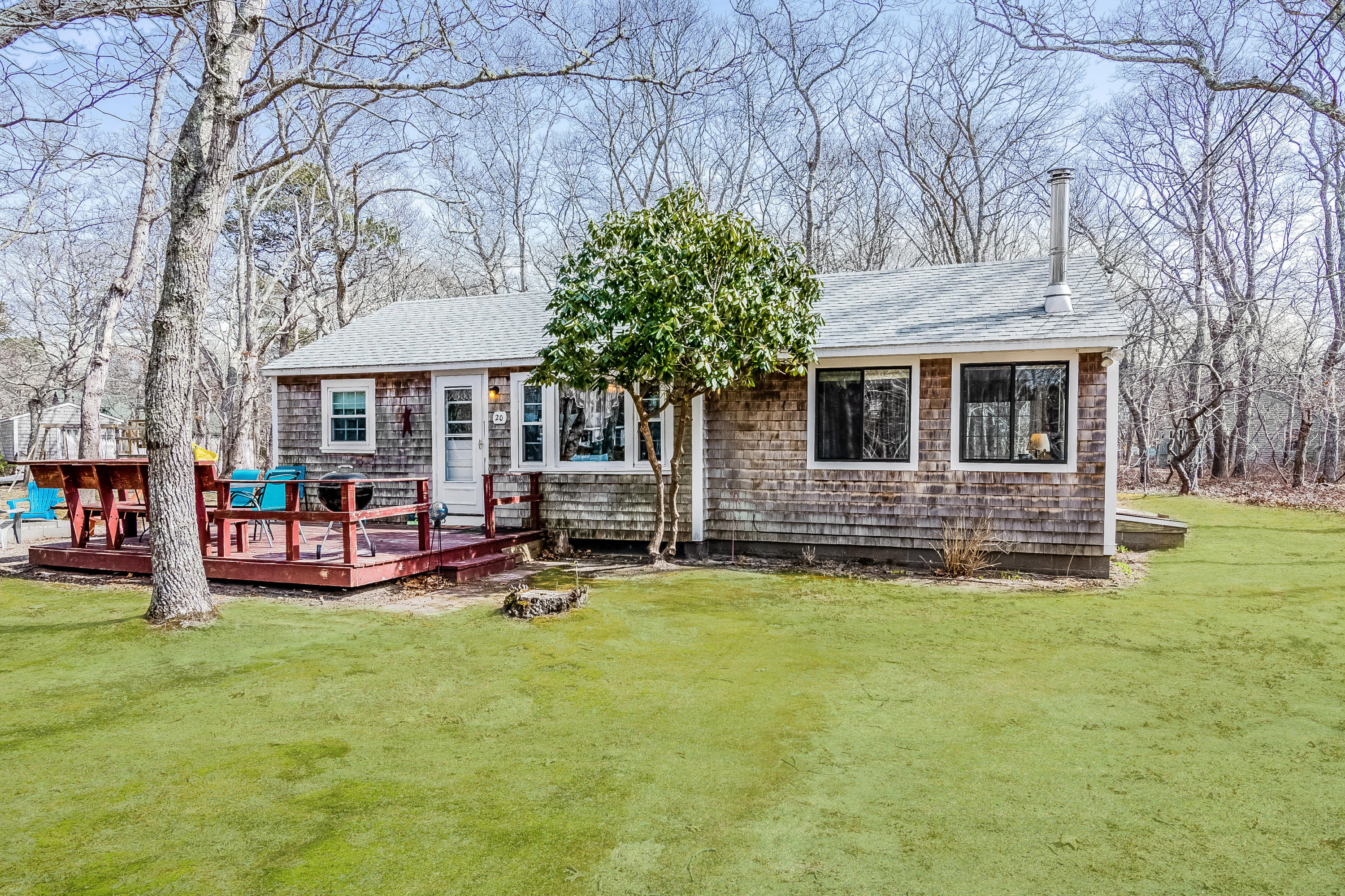 a view of a house with backyard porch and sitting area