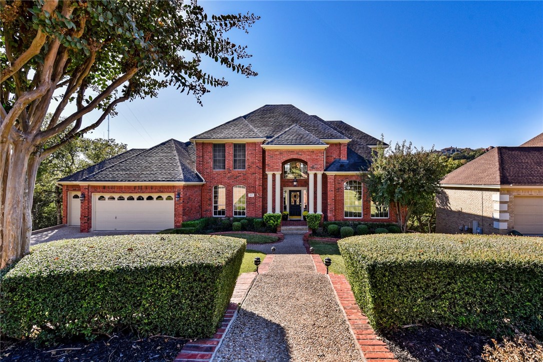 2807 Round Table Road Austin, TX 78746 - Photo 1 of 1 a front view of a house with a yard