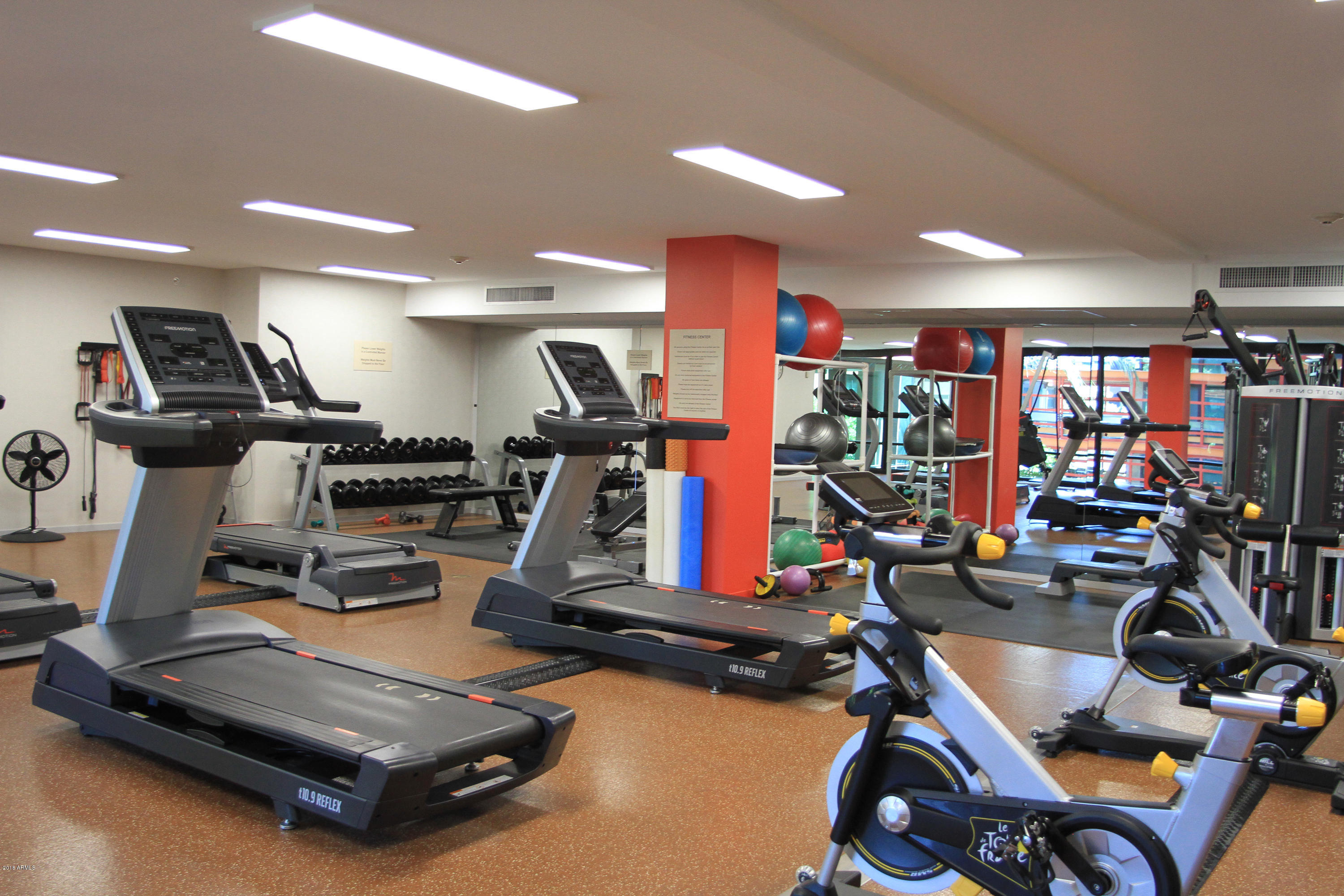 4808 North 24th Street, Unit 605 Phoenix, AZ 85016 - Photo 21 of 27 a room with gym equipment and windows
