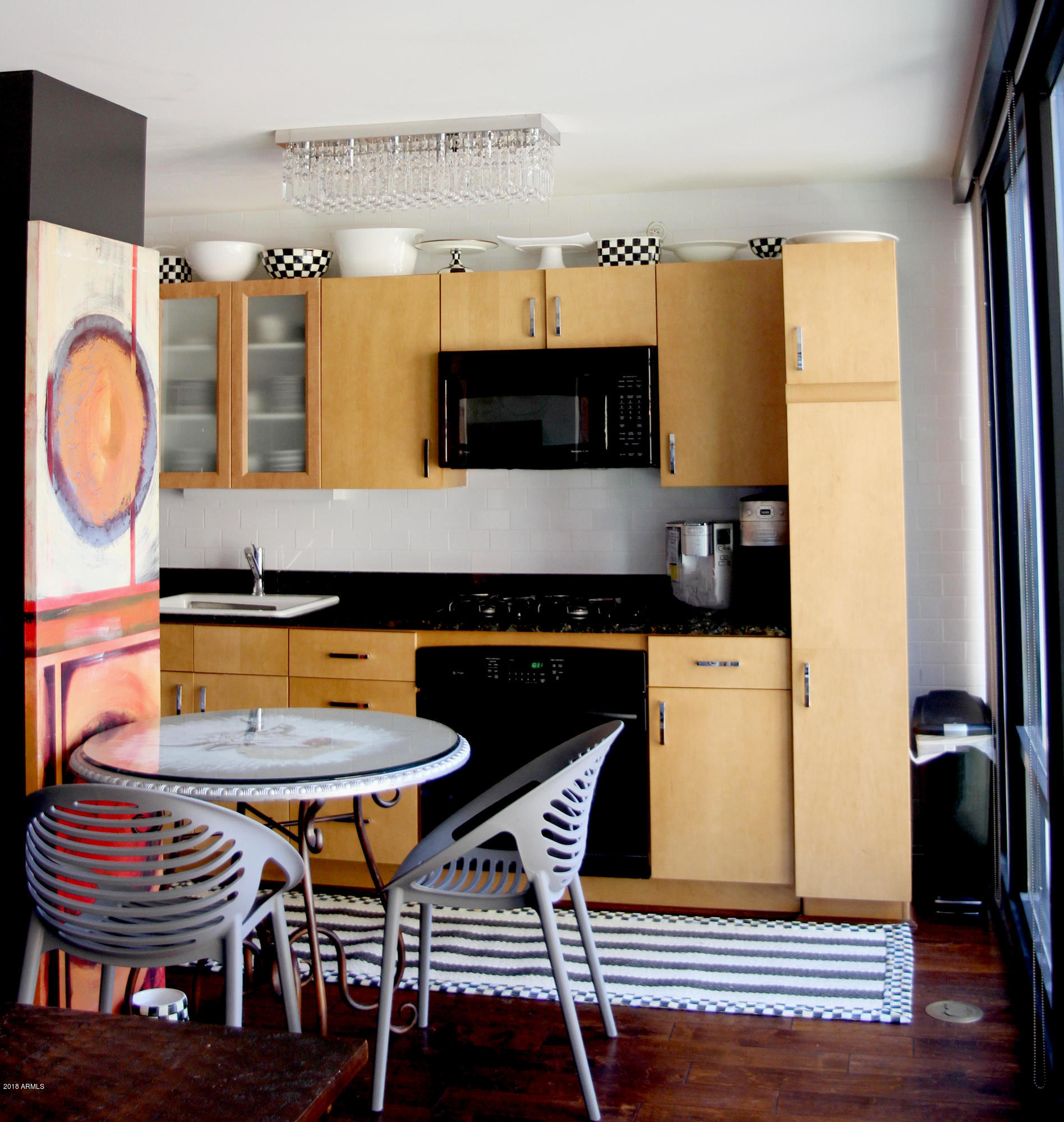 4808 North 24th Street, Unit 605 Phoenix, AZ 85016 - Photo 7 of 27 a kitchen with a table and chairs in it