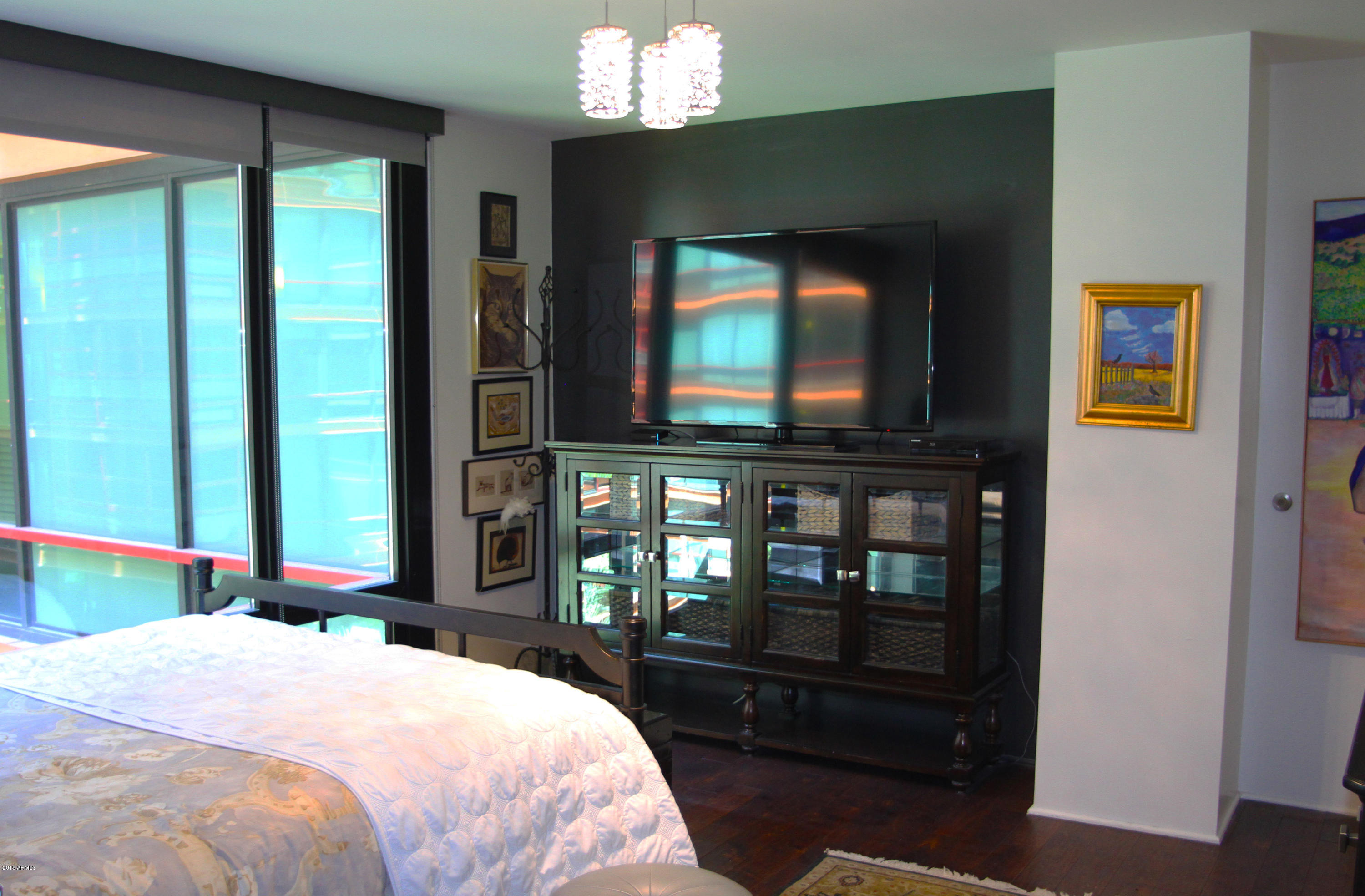 4808 North 24th Street, Unit 605 Phoenix, AZ 85016 - Photo 10 of 27 a bedroom with a bed and a flat tv screen next to a window