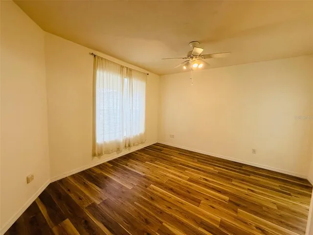 a view of empty room with ceiling fan