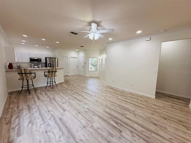 a view of a kitchen with wooden floor and a large window