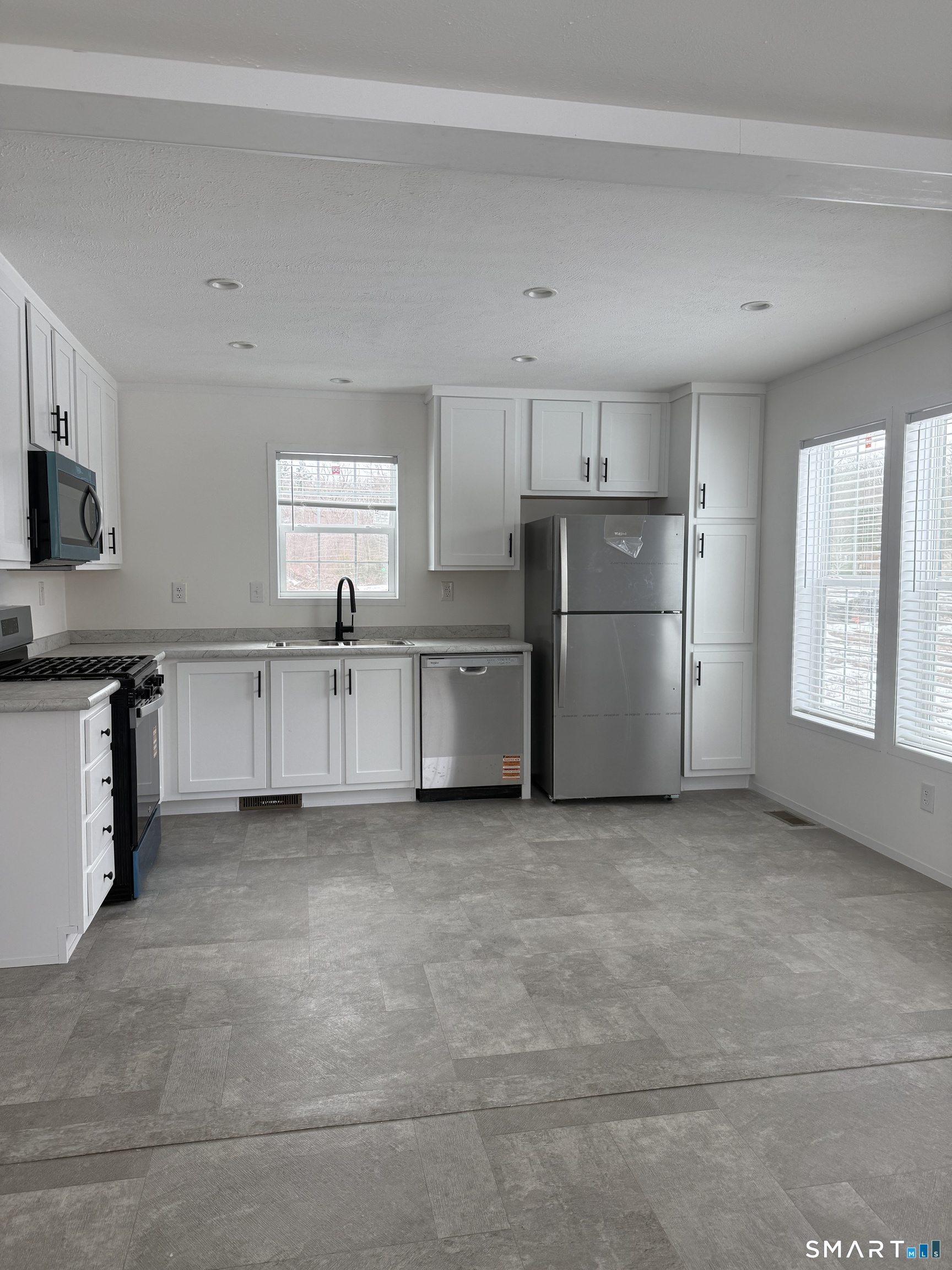 6-421 Norwich-Westerly Road North Stonington, CT 06359 - Photo 2 of 10 a view of kitchen with refrigerator cabinets and furniture