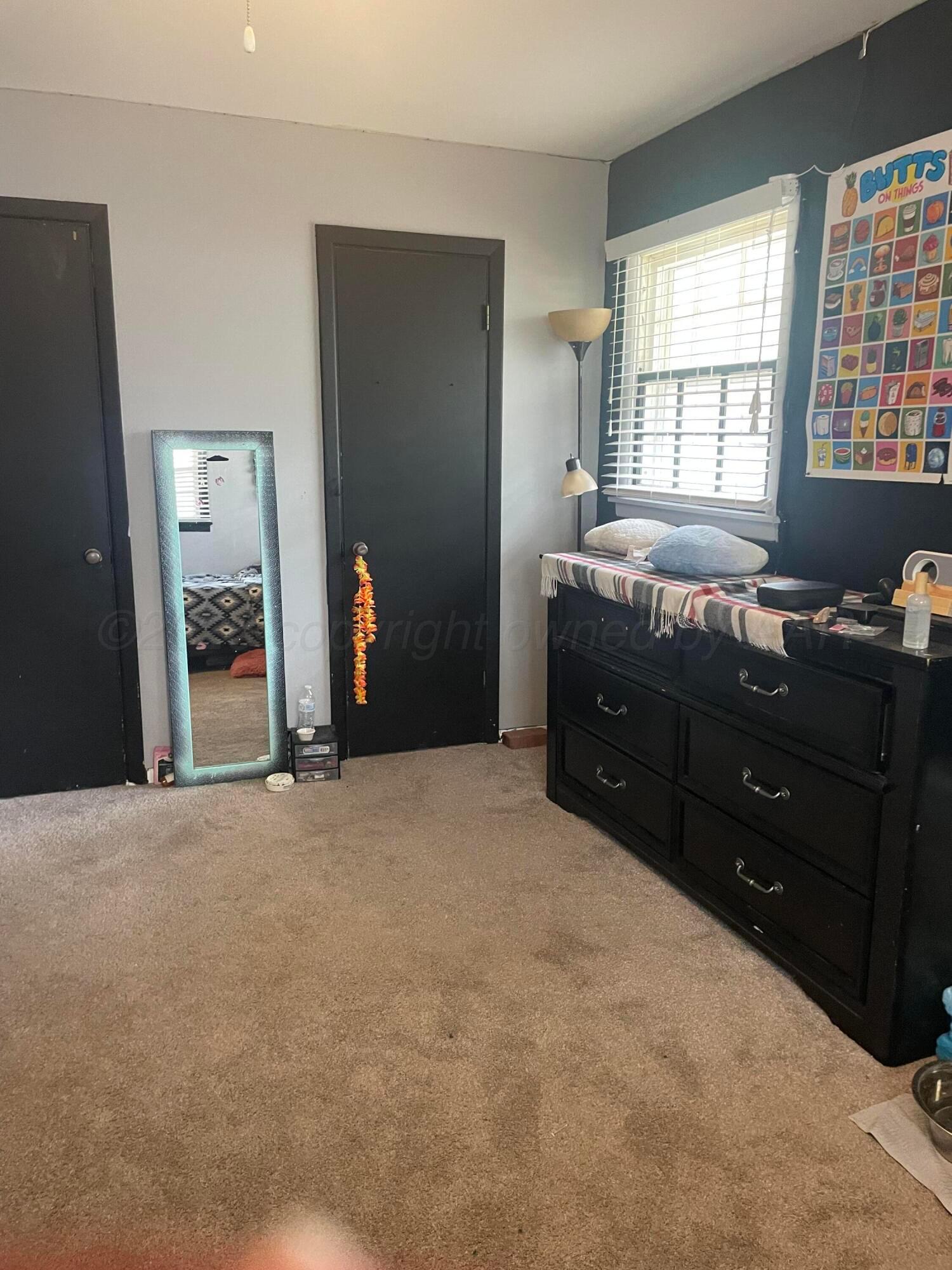 6200 Hanson Road Amarillo, TX 79106 - Photo 16 of 22 a room with a dresser and a window