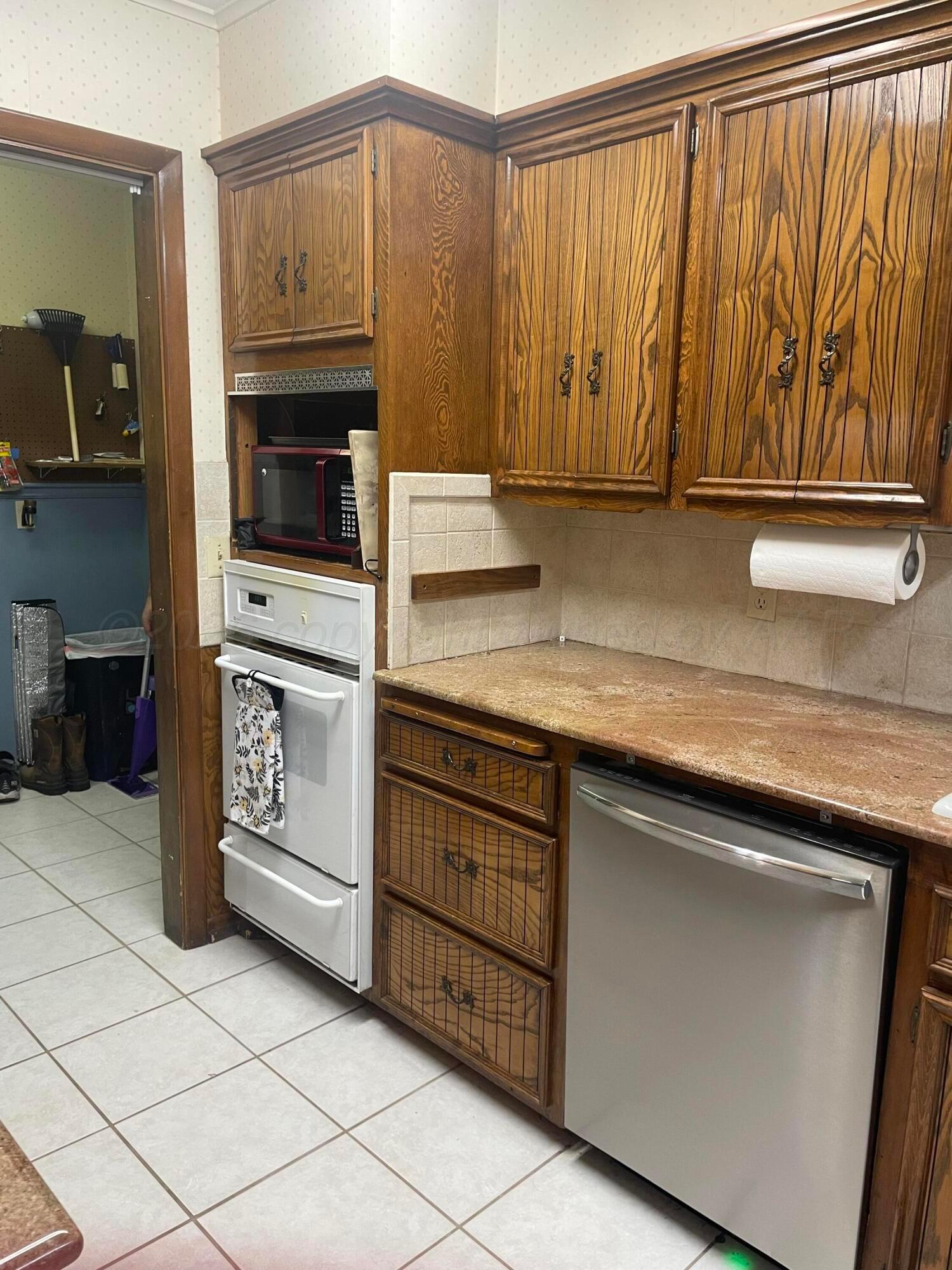 6200 Hanson Road Amarillo, TX 79106 - Photo 2 of 22 a kitchen with stainless steel appliances granite countertop a sink and a microwave