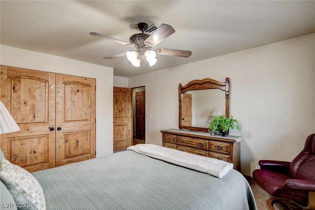 1950 Bowman Road Logandale, NV 89021 - Photo 41 of 81 Natural knotty wood doors and a ceiling fan enhance this inviting bedroom's comfort.