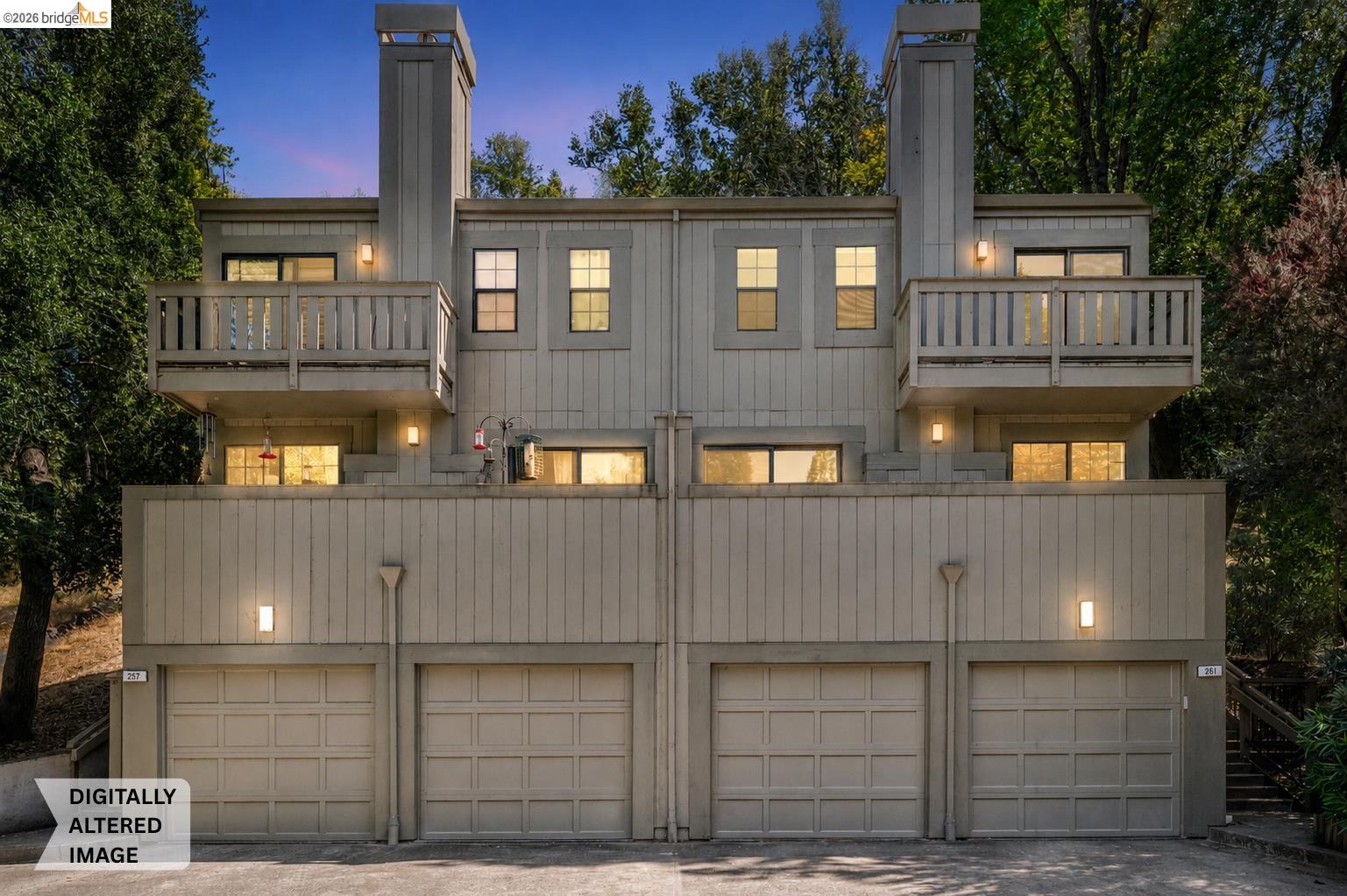 Multi-level facade with panel siding and individual garage access