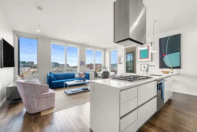 a kitchen with stainless steel appliances granite countertop a stove and a refrigerator