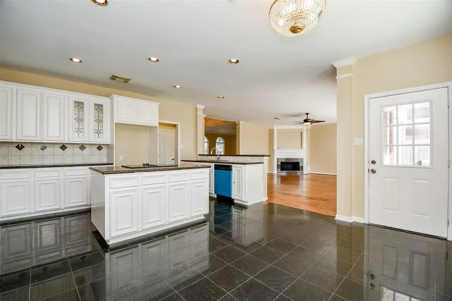 an open kitchen with white cabinets and stainless steel appliances