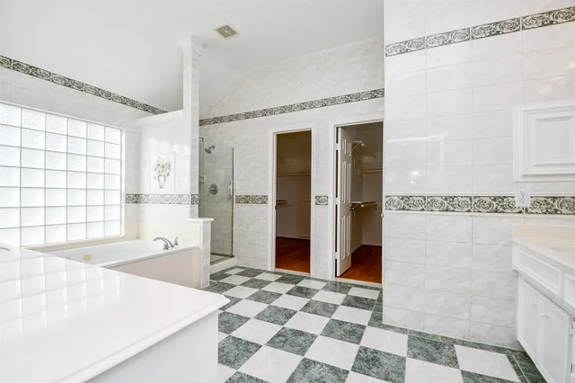 a bathroom with a bathtub a sink and a shower