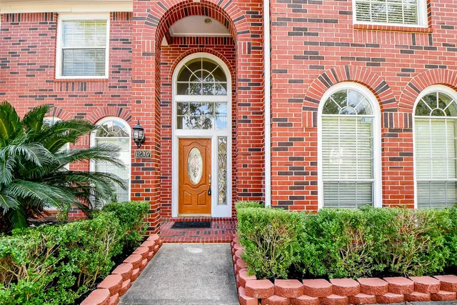 a front view of a house with potted plants