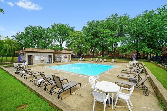 a view of a house with swimming pool and sitting area