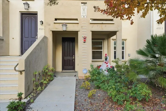 front view of a house with potted plants
