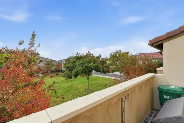 a view of a green field with sitting area