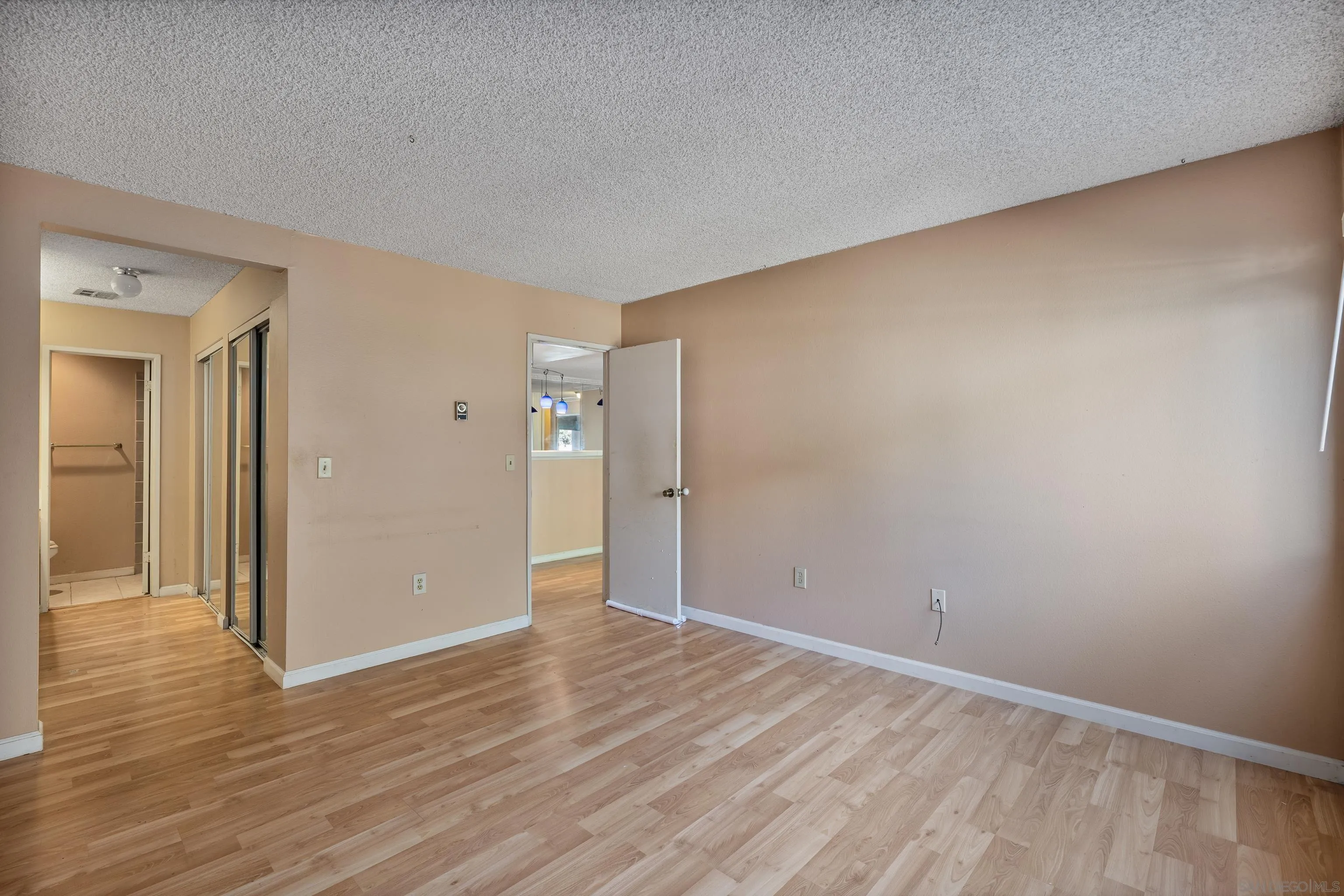 6780 Friars Road, Unit 212 San Diego, CA 92108 - Photo 13 of 25 a view of an empty room and wooden floor