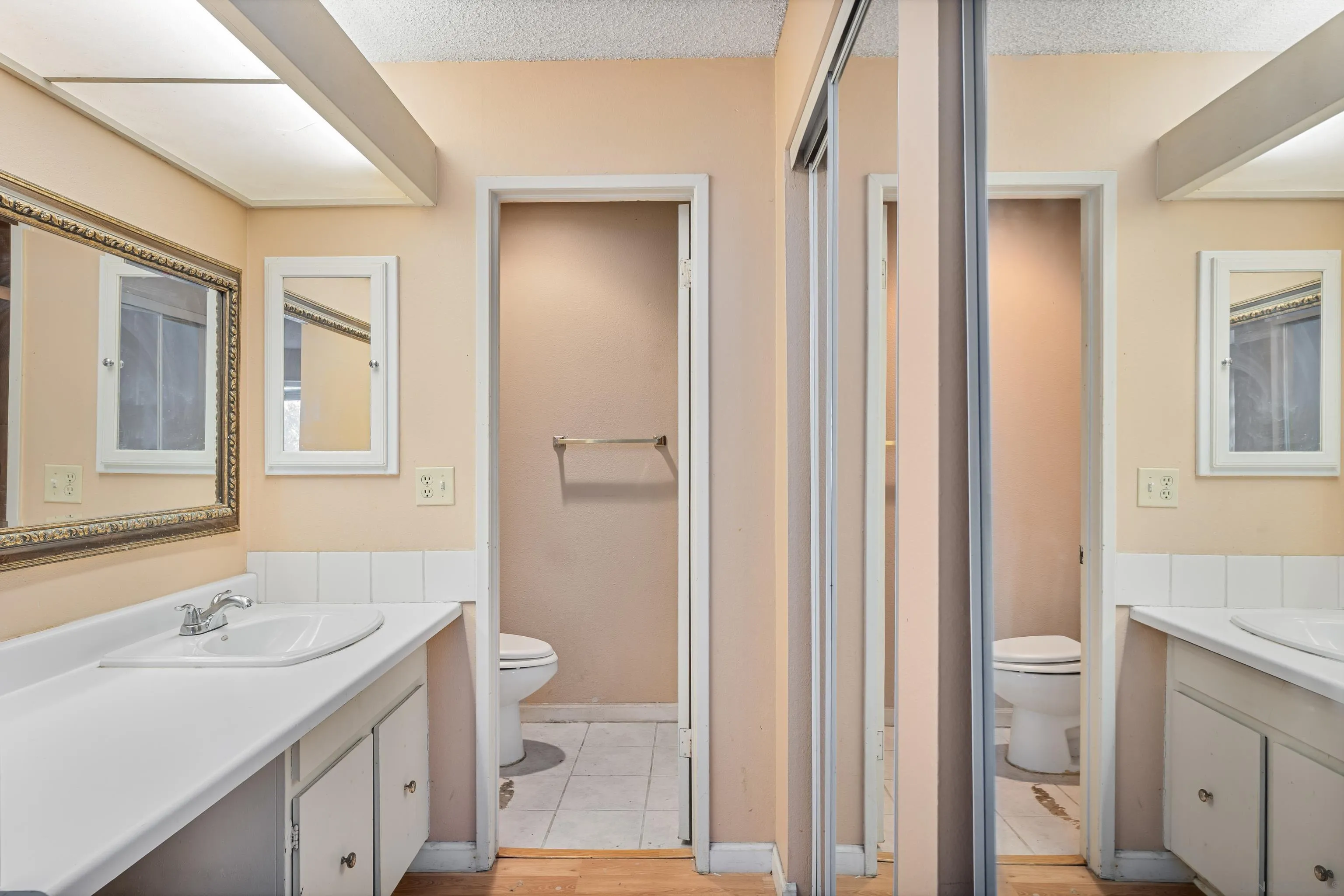 6780 Friars Road, Unit 212 San Diego, CA 92108 - Photo 14 of 25 a bathroom with a sink a toilet and a mirror