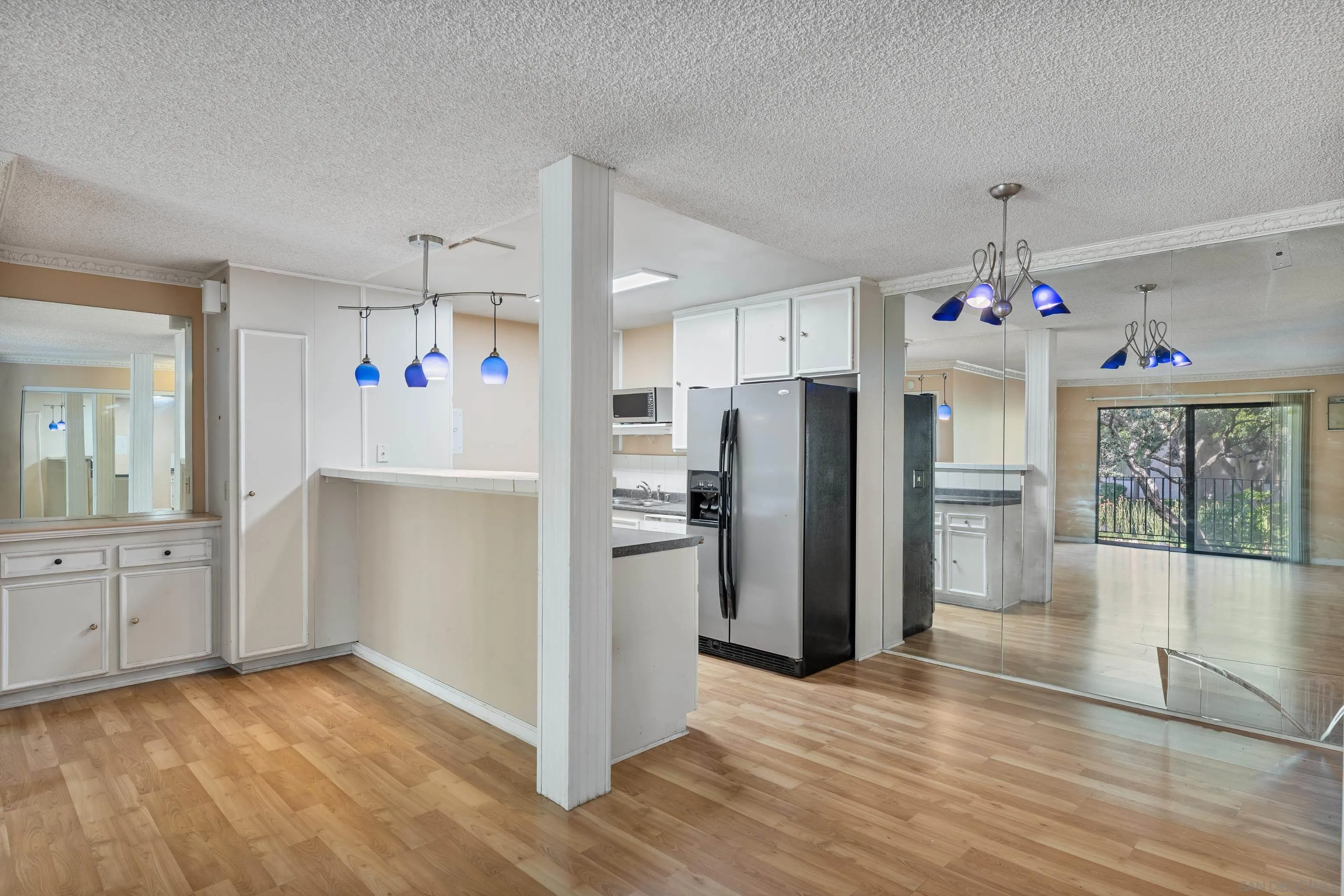 6780 Friars Road, Unit 212 San Diego, CA 92108 - Photo 6 of 25 a view of a kitchen with refrigerator and wooden floor