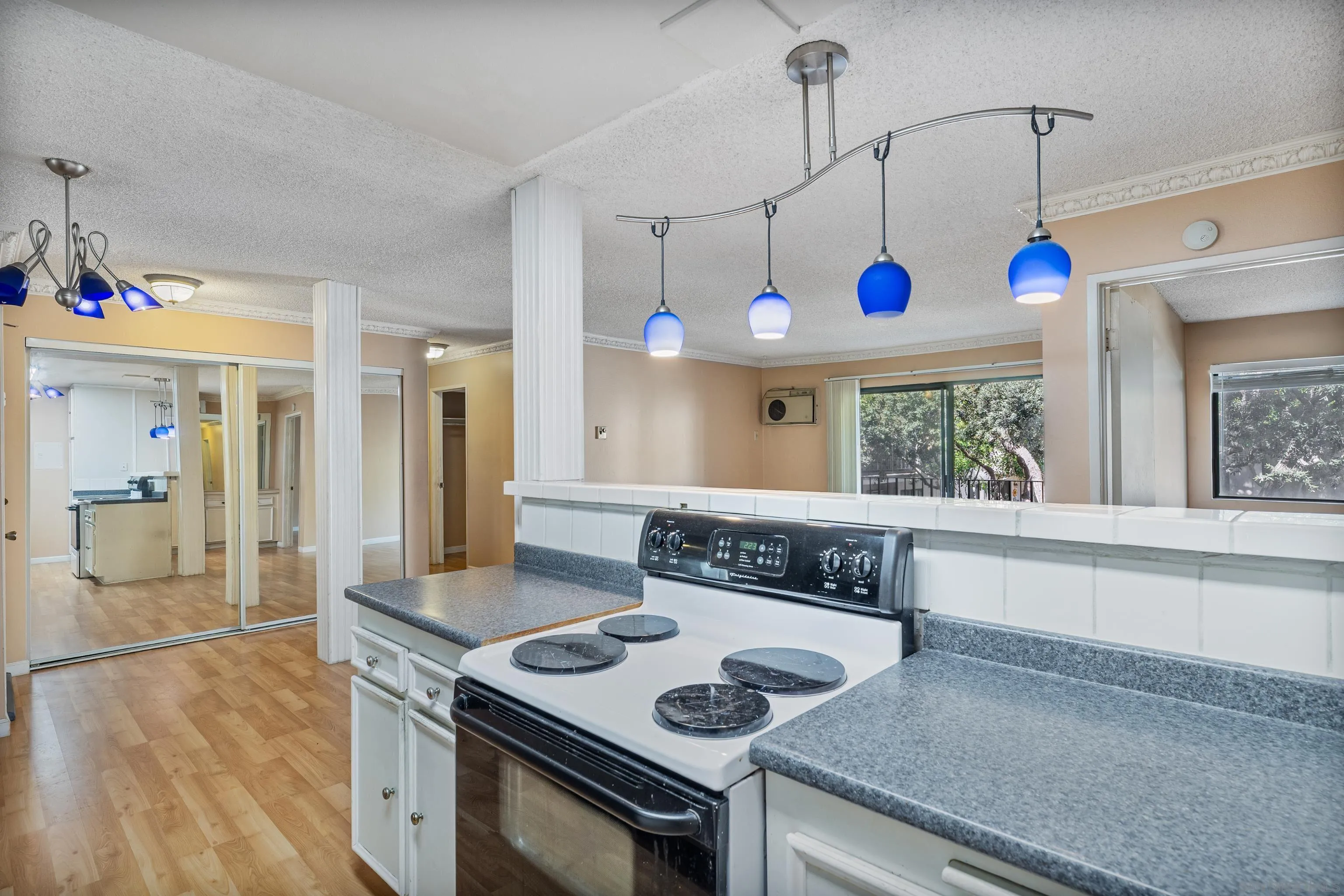 6780 Friars Road, Unit 212 San Diego, CA 92108 - Photo 8 of 25 a kitchen that has a stove and a wooden floor