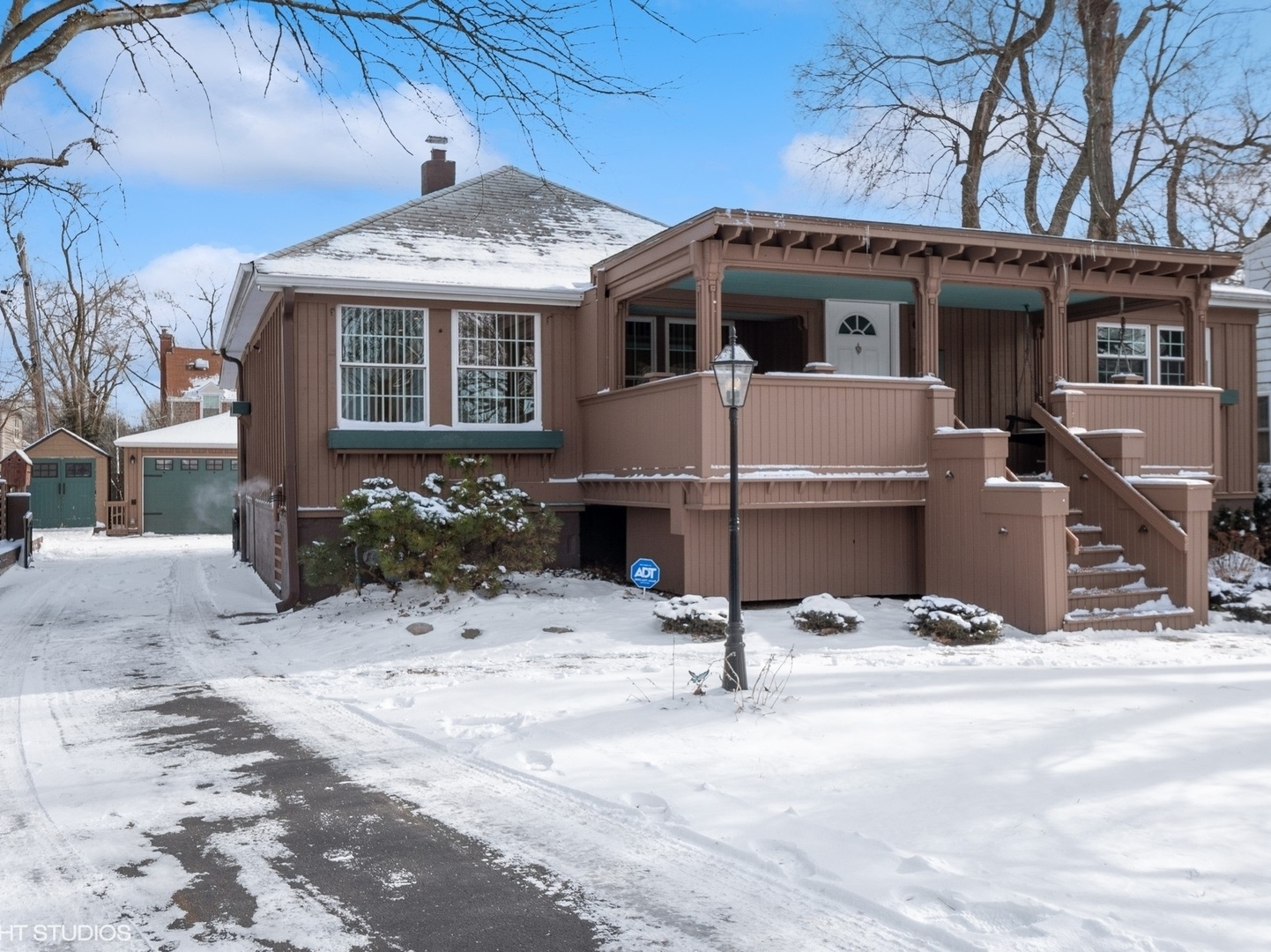 a view of a house with wooden roof and sitting area