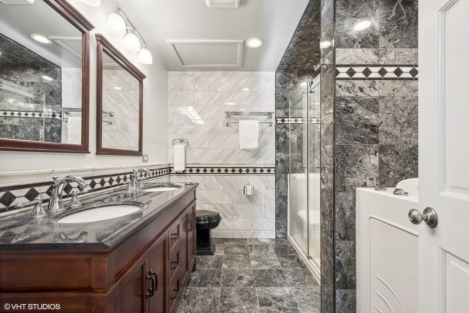 207 North Happ Road Northfield, IL 60093 - Photo 16 of 31 a bathroom with a sink a mirror and a shower