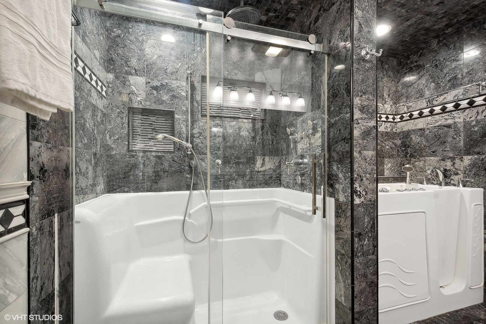 207 North Happ Road Northfield, IL 60093 - Photo 17 of 31 a bathroom with a bathtub and a shower