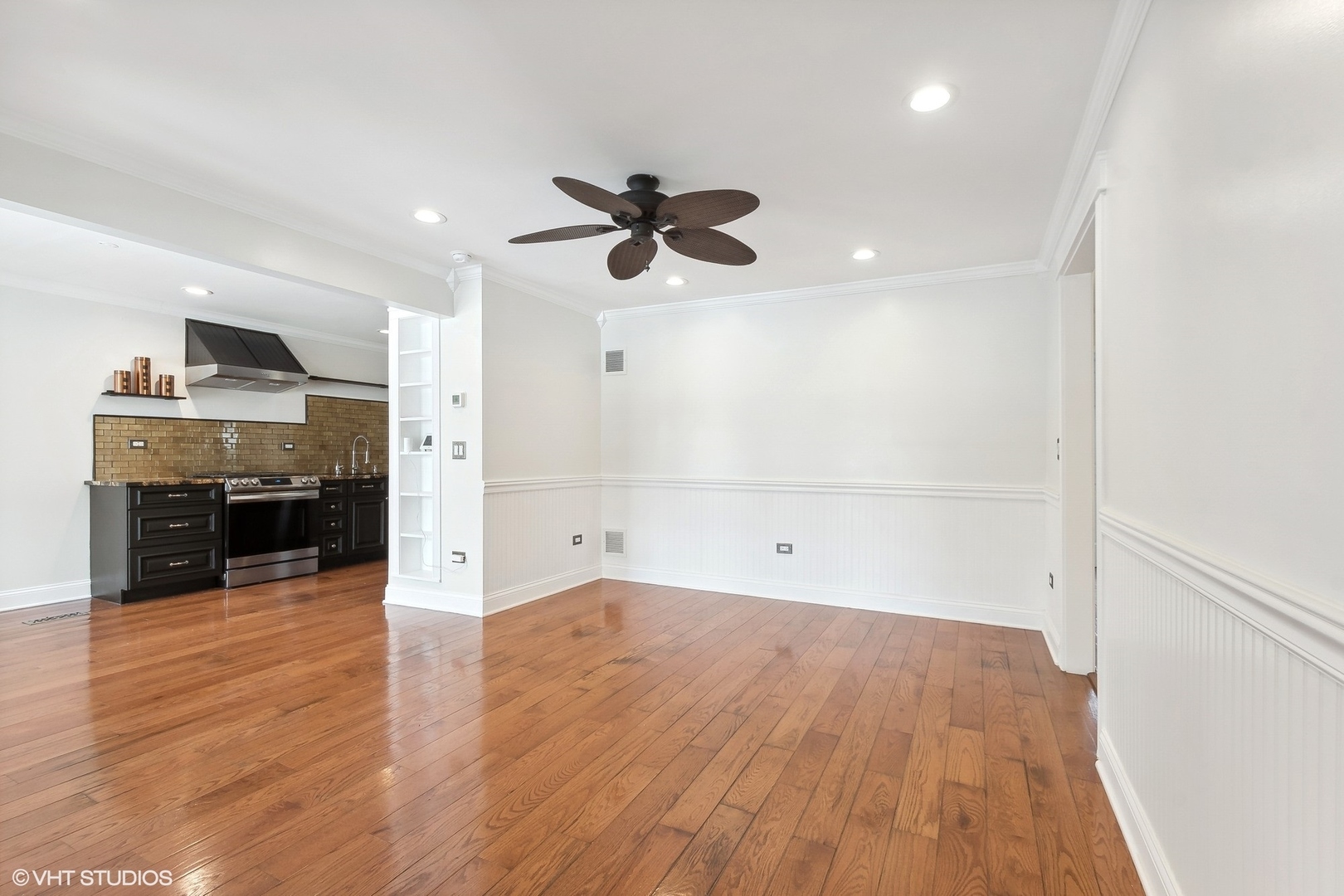 207 North Happ Road Northfield, IL 60093 - Photo 5 of 31 an empty room with wooden floor ceiling fan and windows