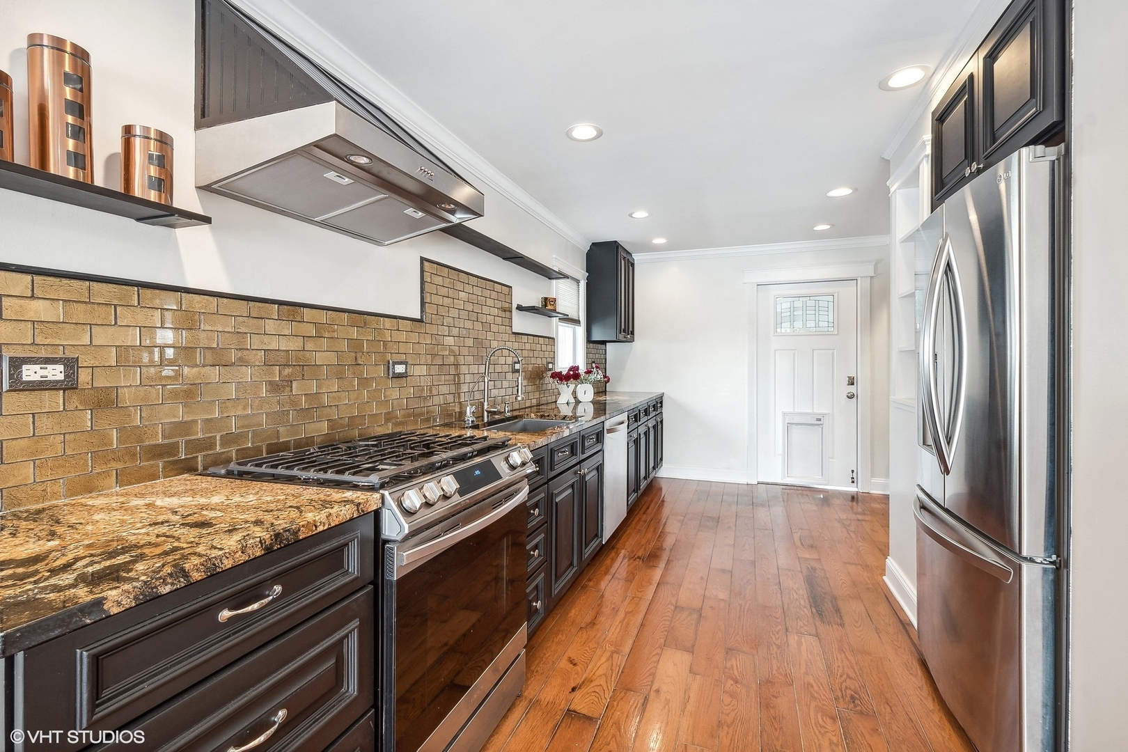 207 North Happ Road Northfield, IL 60093 - Photo 6 of 31 a kitchen with stainless steel appliances granite countertop a stove and a refrigerator