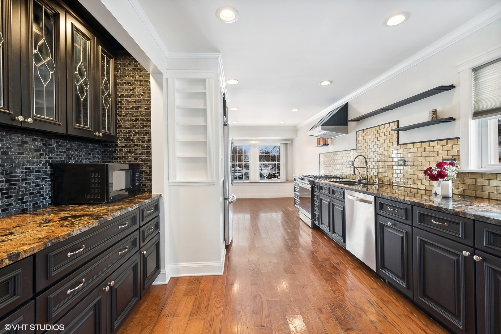 207 North Happ Road Northfield, IL 60093 - Photo 7 of 31 a kitchen with lots of counter top space and wooden floor