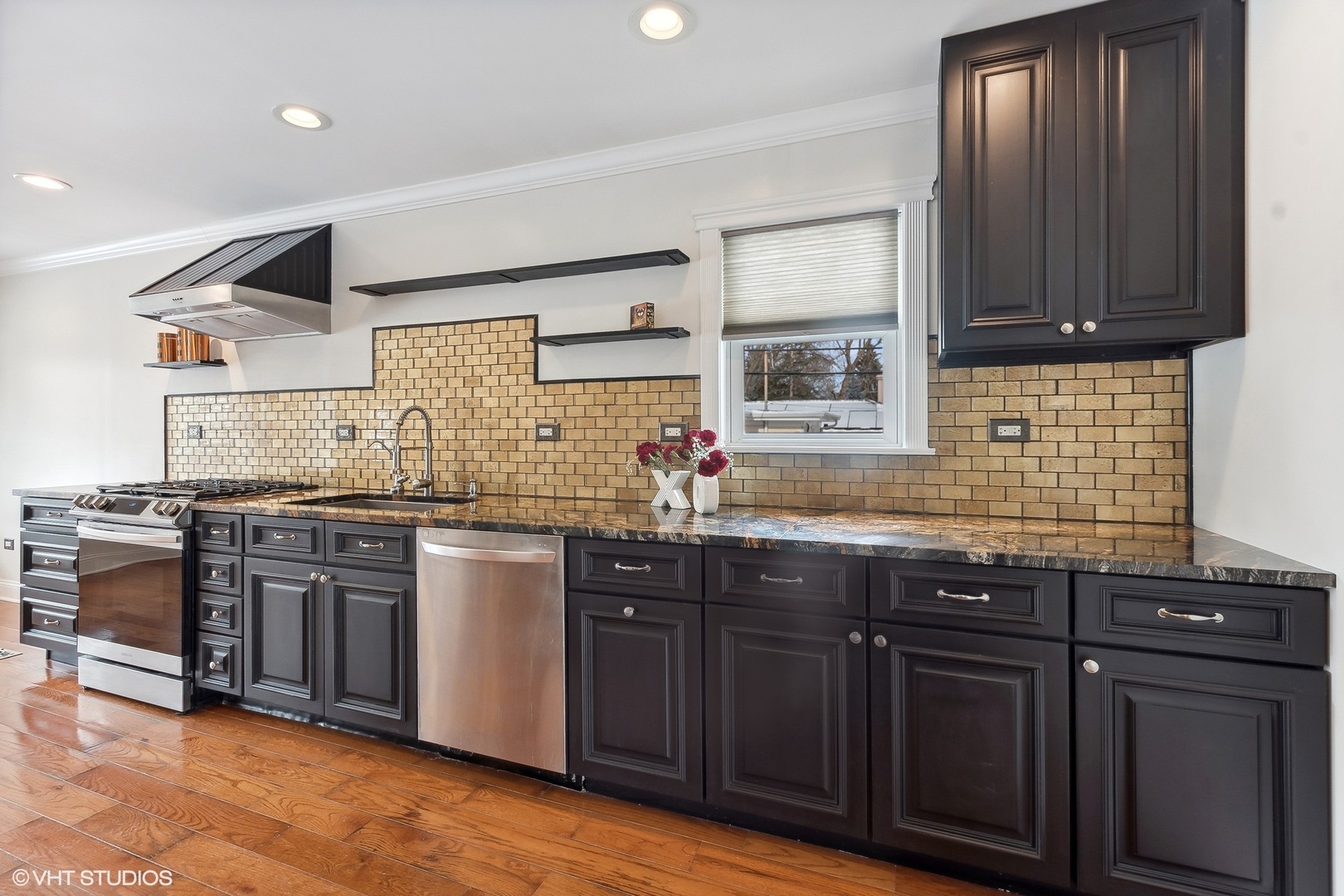 207 North Happ Road Northfield, IL 60093 - Photo 9 of 31 a kitchen with stainless steel appliances granite countertop wooden cabinets and sink