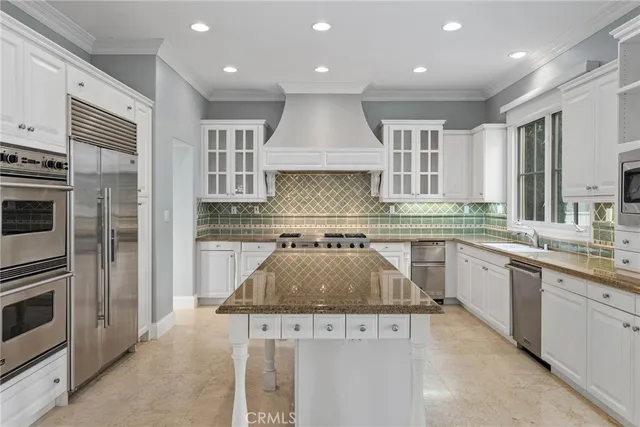 a kitchen with a stove a sink and a microwave