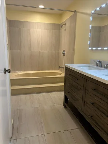 a bathroom with a granite countertop sink a toilet and a mirror