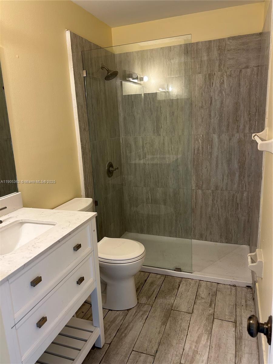 600 Executive Center Drive, Unit 204 West Palm Beach, FL 33401 - Photo 7 of 9 a bathroom with a shower and a toilet