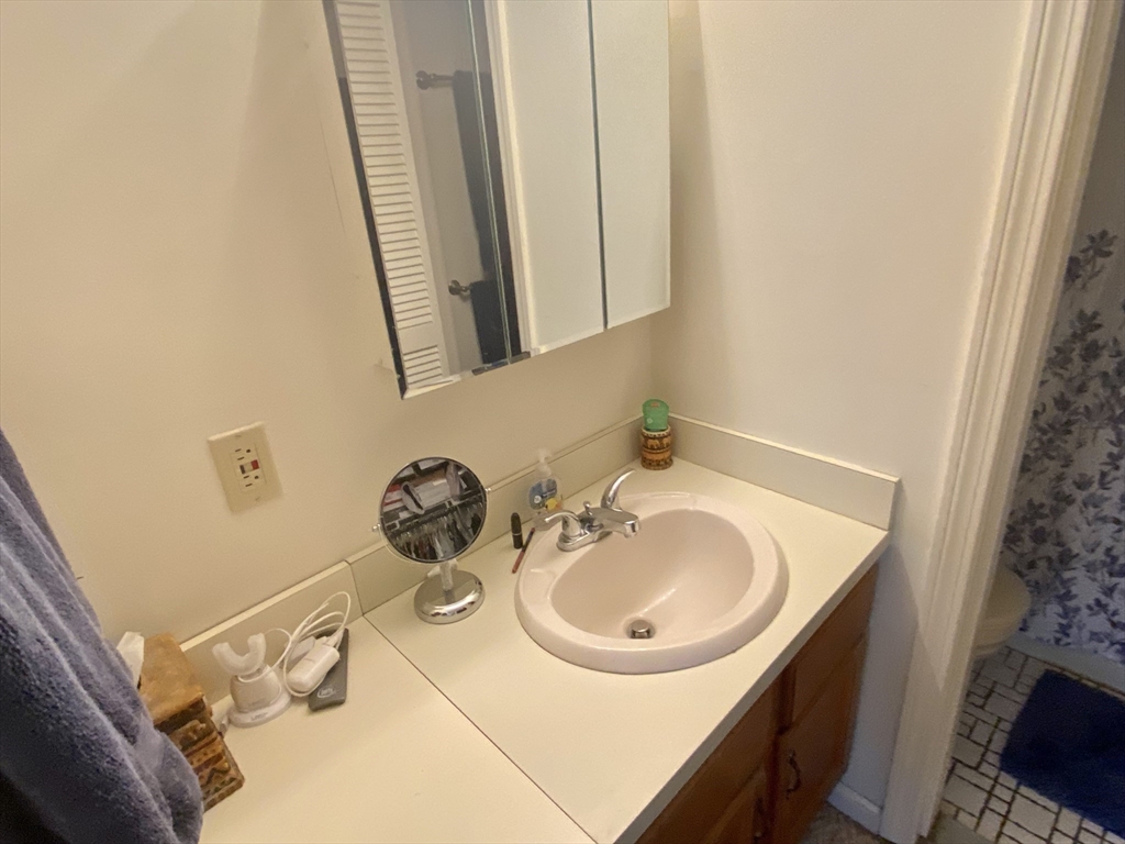 215 Trailside Way, Unit 215 Ashland, MA 01721 - Photo 11 of 15 a bathroom with a sink and a mirror