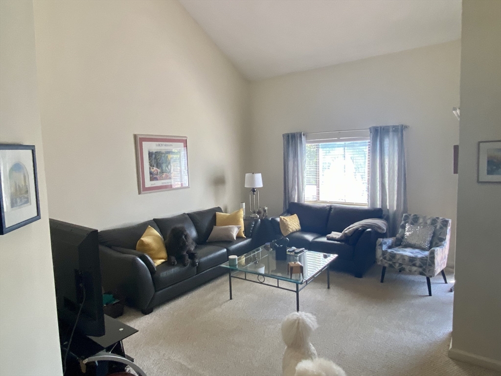 215 Trailside Way, Unit 215 Ashland, MA 01721 - Photo 3 of 15 a living room with furniture and a window