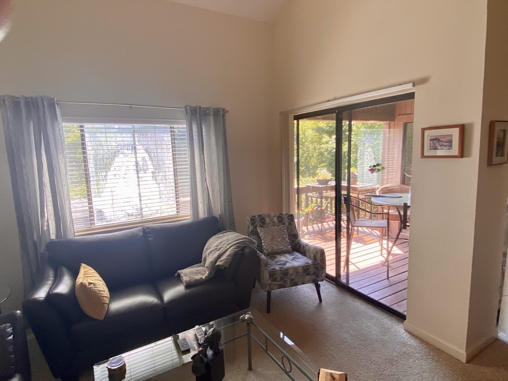 215 Trailside Way, Unit 215 Ashland, MA 01721 - Photo 4 of 15 a living room with furniture and a window