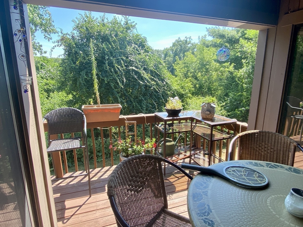 215 Trailside Way, Unit 215 Ashland, MA 01721 - Photo 5 of 15 a view of a dining room with furniture window and outside view