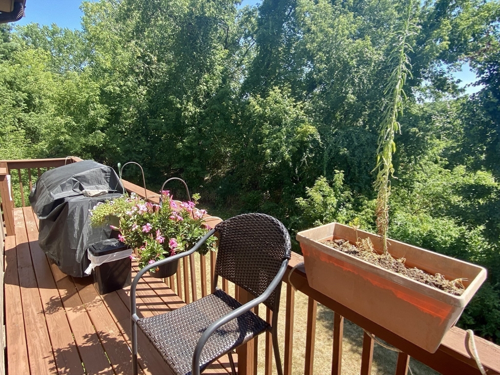 215 Trailside Way, Unit 215 Ashland, MA 01721 - Photo 6 of 15 a view of a chairs and table in the roof deck