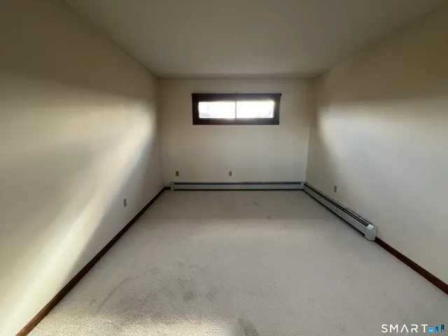 a white toilet sitting next to a bath tub
