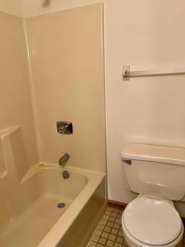 a view of an empty room and a window