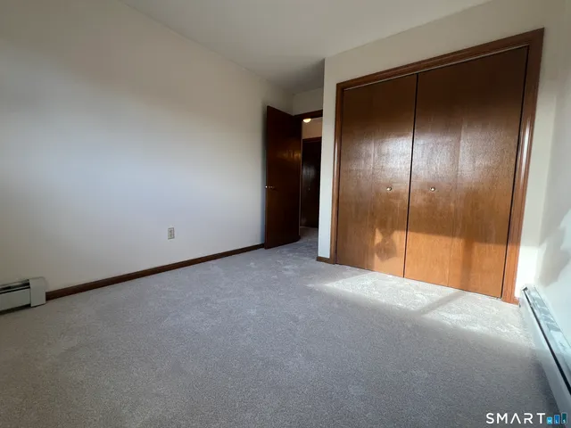 a view of a room with an empty space and a hallway