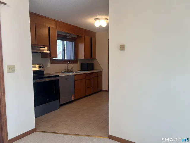 a kitchen with a sink a stove and refrigerator