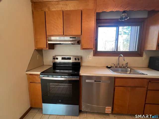 a white toilet sitting next to a white wall