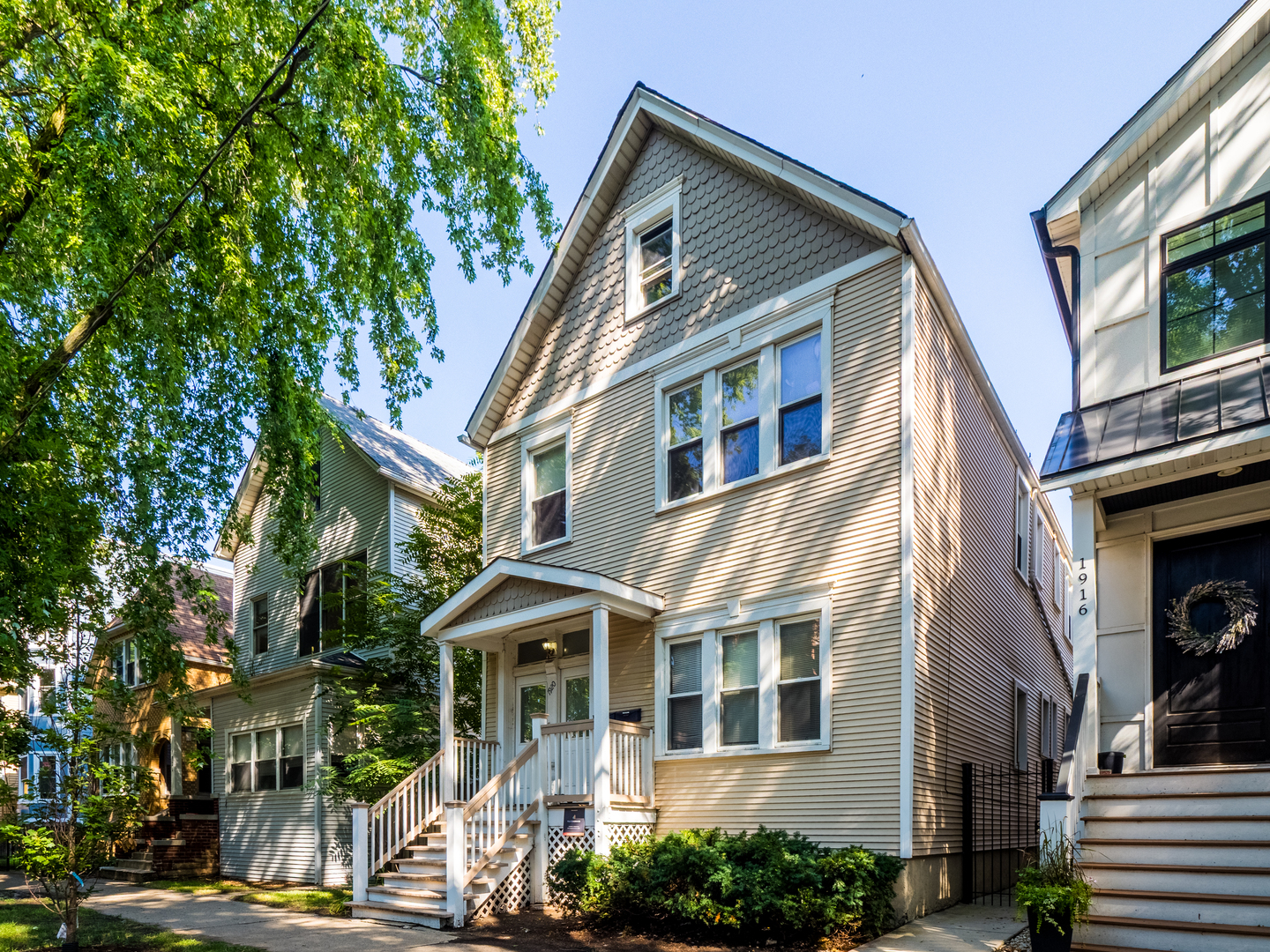 a front view of a residential apartment building with a yard
