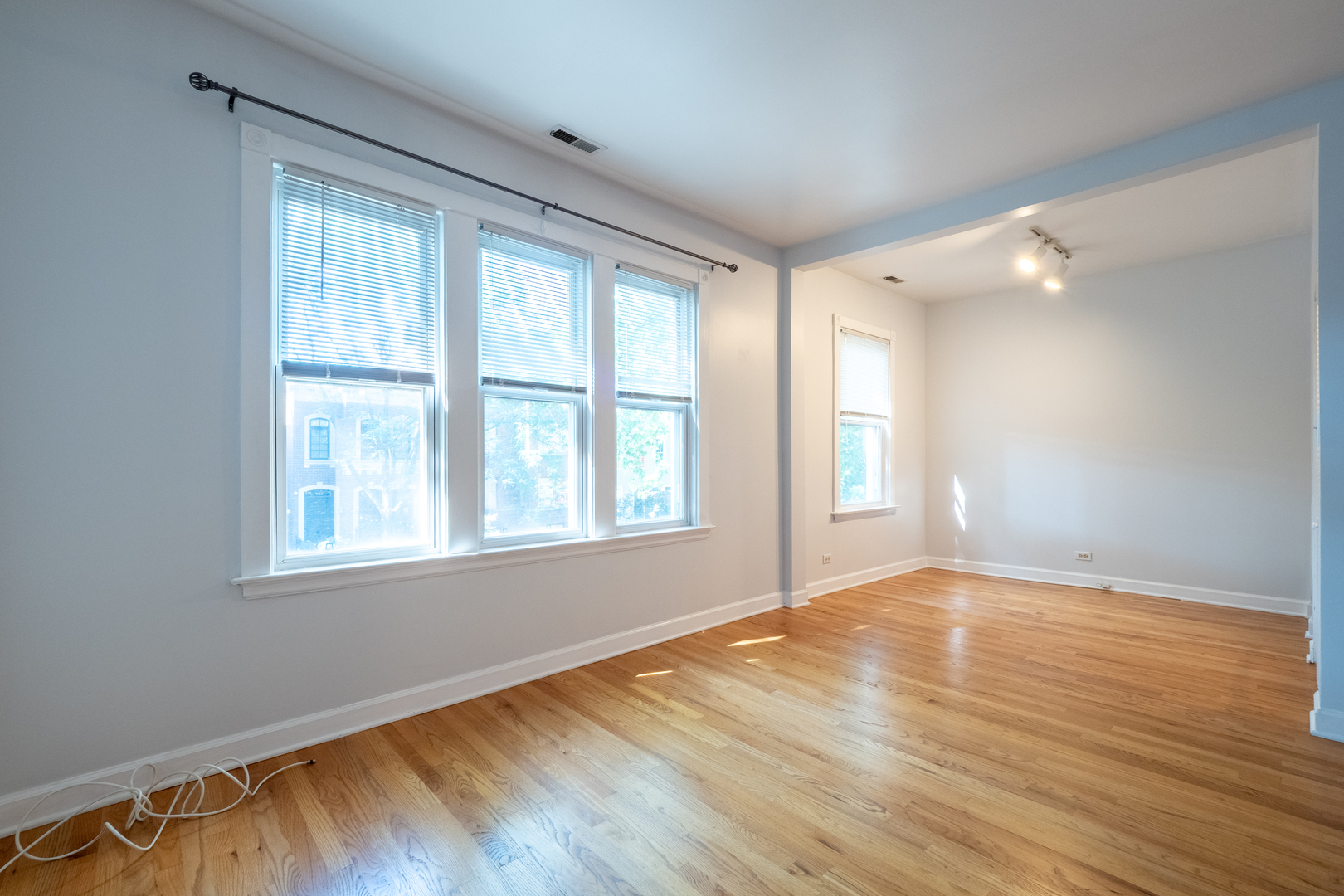 1920 West School Street Chicago, IL 60657 - Photo 17 of 36 a view of an empty room with wooden floor and a window