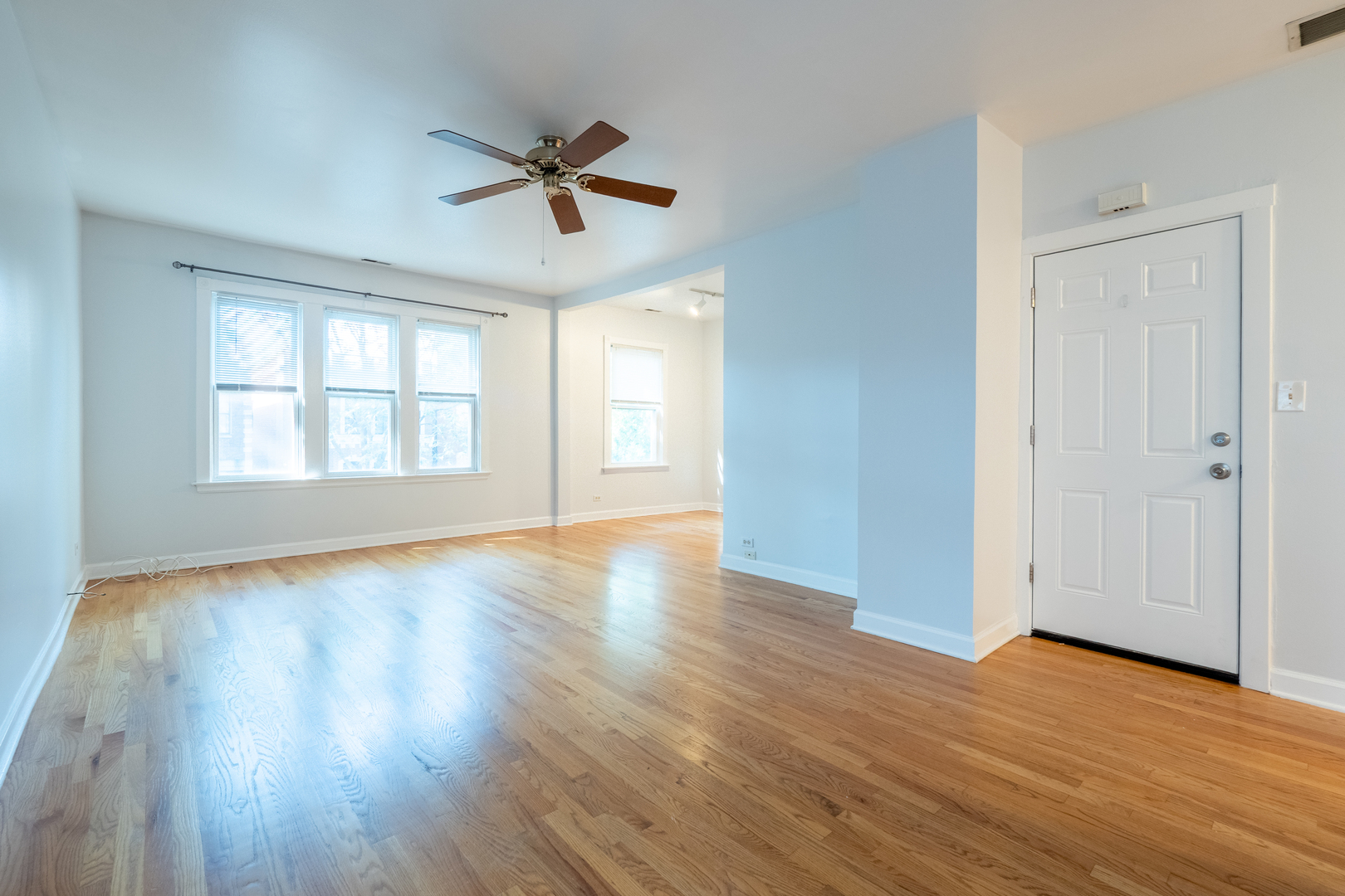 1920 West School Street Chicago, IL 60657 - Photo 21 of 36 a view of an empty room with wooden floor and a window