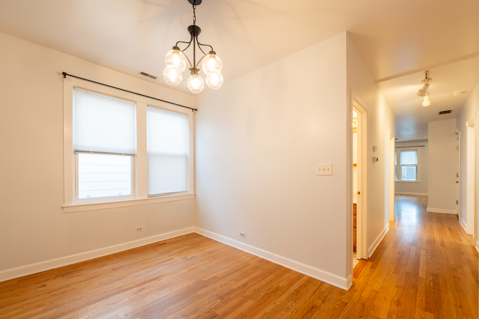 1920 West School Street Chicago, IL 60657 - Photo 25 of 36 a view of an empty room with wooden floor and a window