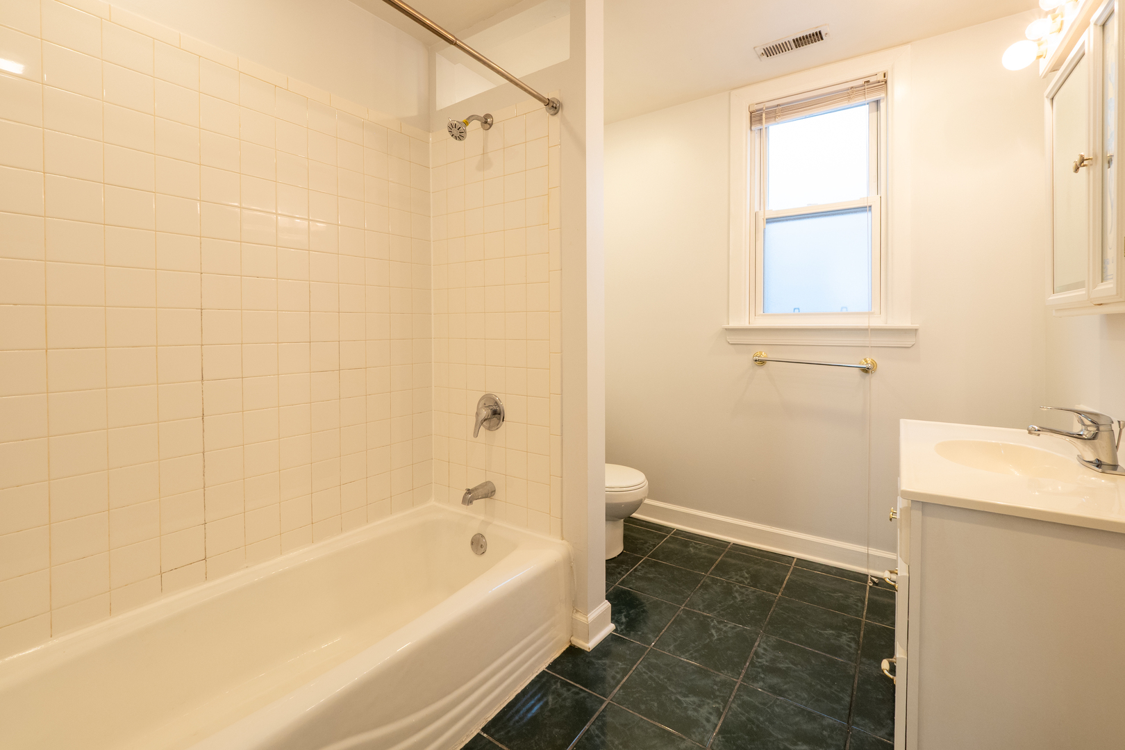 1920 West School Street Chicago, IL 60657 - Photo 27 of 36 a bathroom with a bathtub and a shower