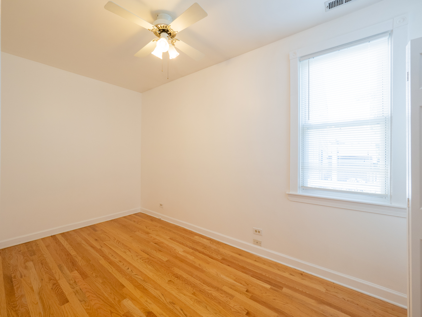 1920 West School Street Chicago, IL 60657 - Photo 29 of 36 an empty room with a window and a fan